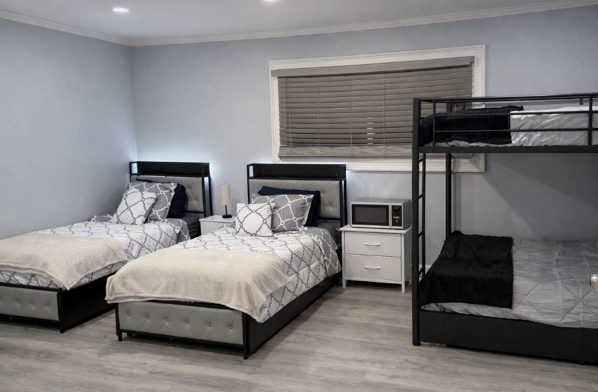A bright, furnished shared bedroom inside the real Activity House