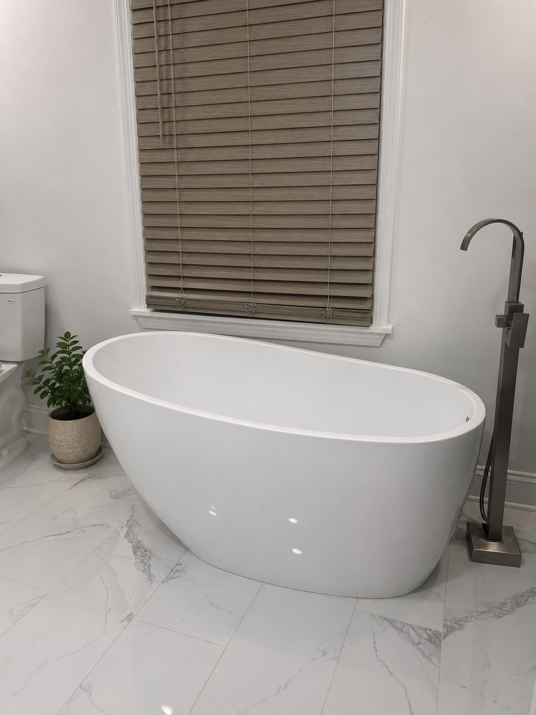 A bright bathroom with a freestanding tub inside Poetry House
